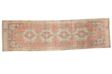 Distressed vintage Oushak runner with repeating medallions in muted cinnabar, blush, and gray, 2'7