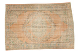 Distressed Oushak carpet, faded peach field with scalloped roundel medallion in mint and blue.
