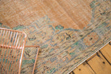Decorative distressed Oushak with mint green, pale royal blue floral details.
