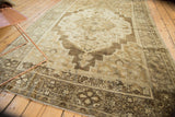 Hand-knotted vintage Oushak carpet corner, with intricate bronze border and ivory fringe detail.