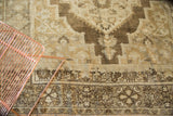 Vintage Turkish Oushak rug with intricate border design and open ivory, bronze main field.