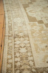 Intact side selvage and finely detailed bronze and ivory floral patterns on a vintage Oushak rug.