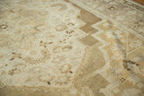 Even pile texture of the hand-knotted Oushak rug in antique ivory and pale bronze.
