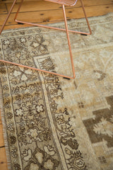 Hand-knotted Oushak border detail with ivory, pale bronze, and dark brown traditional motifs.