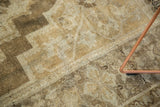 Hand-knotted vintage Oushak rug showcasing a muted bronze and ivory corner spandrel pattern.