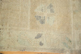 Textured vintage Oushak rug pile with ivory abrashes, faded blue, and short fringe.