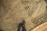 Vintage Oushak carpet with intricate chocolate brown geometric border and floral top niche.