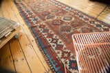 Moghan Kazak runner's blue and red Laleh Abassi pawn border with ivory gul motifs.