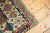 Antique Moghan Kazak rug corner showcasing geometric guls, Laleh Abassi pawn motif border, and fringe.
