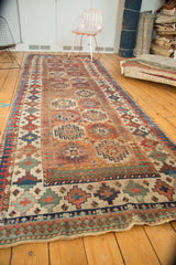 Antique Moghan Kazak rug border detail: Laleh Abassi pawn motif, mallard green, sky blue, red, and ivory pile.