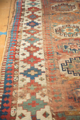 Laleh Abassi pawn motif with geometric gul patterns in pomegranate, sky blue, and ivory.