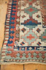Antique Moghan Kazak runner fringe and geometric border with pawn motif in red and blue.