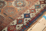Antique Moghan Kazak rug with geometric gul motifs and reciprocating pawn border.