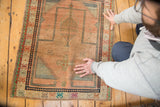 Soft pile of vintage Oushak prayer rug, showcasing apricot and blue checker motif.