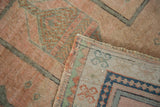 Vintage Oushak rug's corner, showing hand-knotted pile, intricate motif, and tightly woven back.
