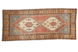 Distressed Oushak runner features double ivory medallions, geometric motifs, dusty red, and oxidized silver.