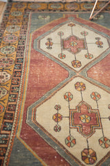 Pinwheel and geometric vinery details on distressed Oushak runner, ivory and eggplant.
