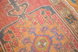 Distressed Oushak runner detail: faded red, orange, blue geometric motifs with soft wear.