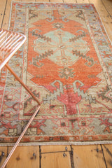 Distressed Oushak runner's textured pile, serrated motifs, and foundation showing through.
