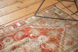 Distressed Oushak rug runner's textured pile, showing cherry red, platinum, and ivory hues.