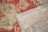 Distressed hand knotted Oushak rug pile showing even wear and foundation weave.