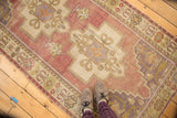 Oushak runner with rams horn motif, floral palmettes, germinating flowers in mauve and eggplant.
