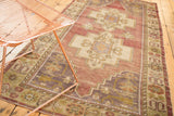 Vintage Oushak rug corner, germinating floral border, eggplant, mauve, antique ivory tones.