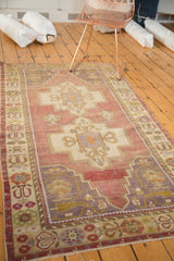 Vintage Oushak runner showing double medallion, rams horn motifs in dusty aubergine, ivory.