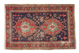 Finely woven Antique Heriz rug with indigo and cherry red double starburst medallions. Early 20th century.