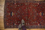 Finely woven Lilihan rug with intricate Herati motif and oversized floral elements in wine red and blue.