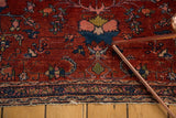 Worn end, intricate Herati-inspired border of vintage Lilihan rug in wine raspberry and indigo.