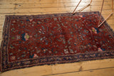Lilihan rug corner: intricate Herati floral motif, wine red and indigo, with tattered fringe.