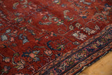 Traditional vintage Lilihan rug detail with red Herati floral motifs and aged indigo border.