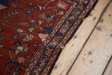 Vintage Lilihan rug border detail: finely woven wine red field, indigo, blush floral patterns, white knots.