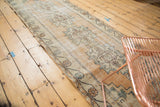 Worn pile and faded medallion pattern of a vintage Distressed Oushak runner.