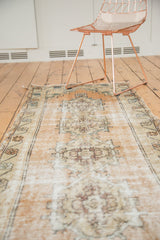 Distressed vintage Oushak rug runner showing worn pile, pale peach, and antique ivory.