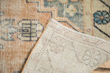 Distressed vintage Oushak runner pile and hand-knotted foundation showing even wear.