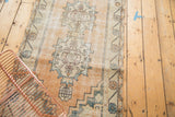 Faded pale peach field and stylized motifs of a vintage distressed Oushak runner.