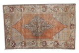 Vintage distressed Oushak rug, faded burnt orange geometric medallion, slate blue palmette border.