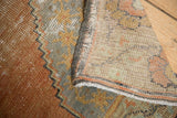 Hand-knotted foundation and distressed burnt orange-blue pile of the vintage Oushak rug.