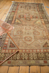 Distressed Anatolian runner with a rectilinear medallion and classic hook and latch motifs.