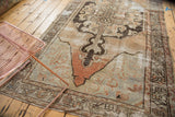 Distressed Oushak runner's roundel medallion with abrash and muted slate blue, charcoal tones.