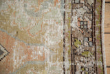 Distressed vintage Oushak rug's worn pile, visible foundation, secured edge, muted sage, peach, blue.