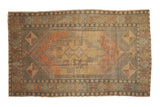 Vintage Distressed Oushak rug, oversized medallion, pinwheel corners, faded aubergine and burnt orange tones.