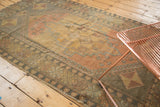 Distressed Oushak rug corner, pinwheel spandrel, and border in faded aubergine and bronze tones.