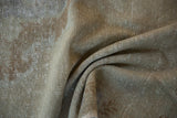 Vintage distressed Oushak rug pile showcasing worn knot heads, faded bronze, and ivory tones.