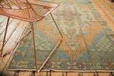Distressed vintage Oushak runner, faded teal stepped corner spandrel, and colorful floral border.
