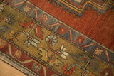 Hand-knotted vintage Anatolian rug border displaying terra cotta, bronze, blue floral motifs.