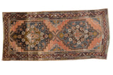 Vintage distressed Anatolian runner features double stepped medallion, faded brick, charcoal, and ivory hues. 4'9