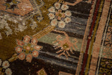 Distressed Anatolian rug detail: olive, peach, and blue floral motifs, with visible foundation wear.